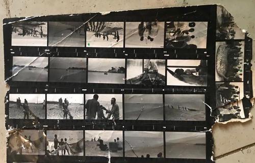 Contact sheet of black-and-white photographs showing people at a beach