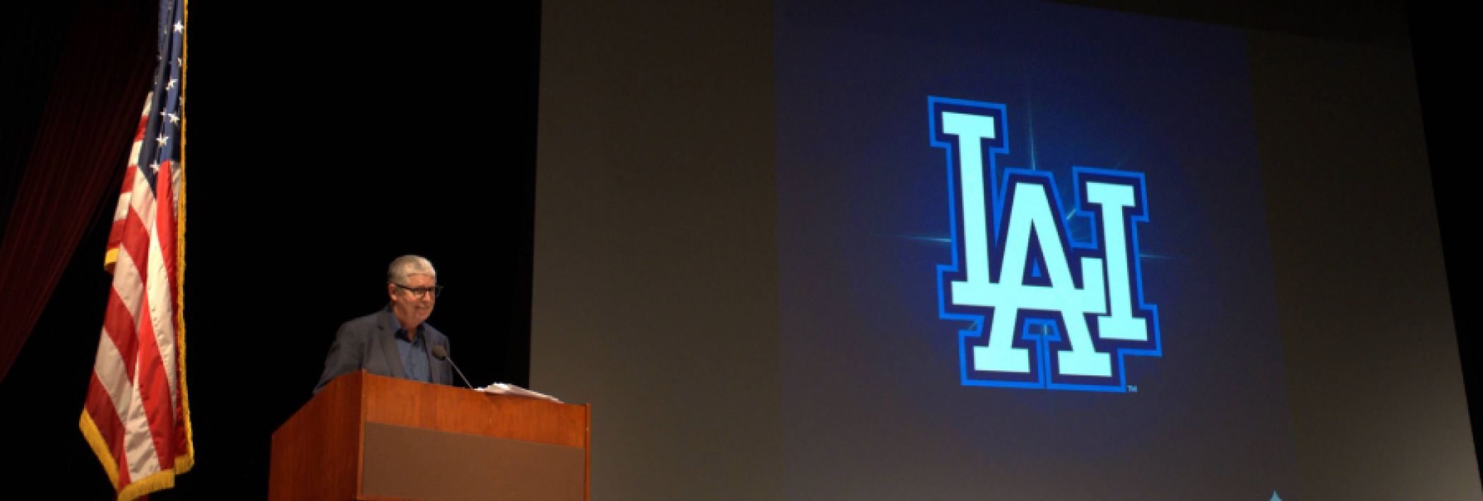 Peter Lunenfeld presenting a slide with LAI icon